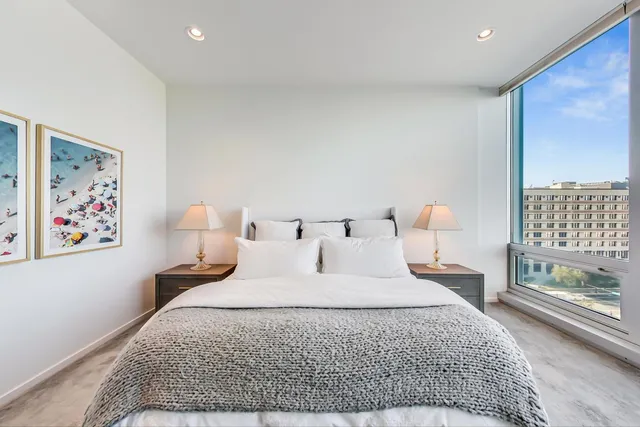 a bedroom with a large bed and a flat screen tv