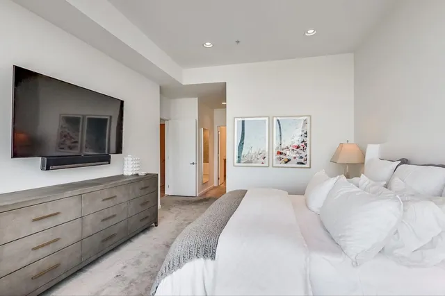a spacious bathroom with a double vanity sink mirror and bathtub