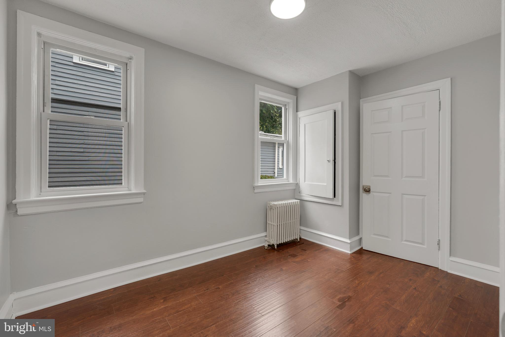 121 Bridgeboro Street Riverside, NJ 08075 - Photo 13 of 34 a view of an empty room with wooden floor and a window