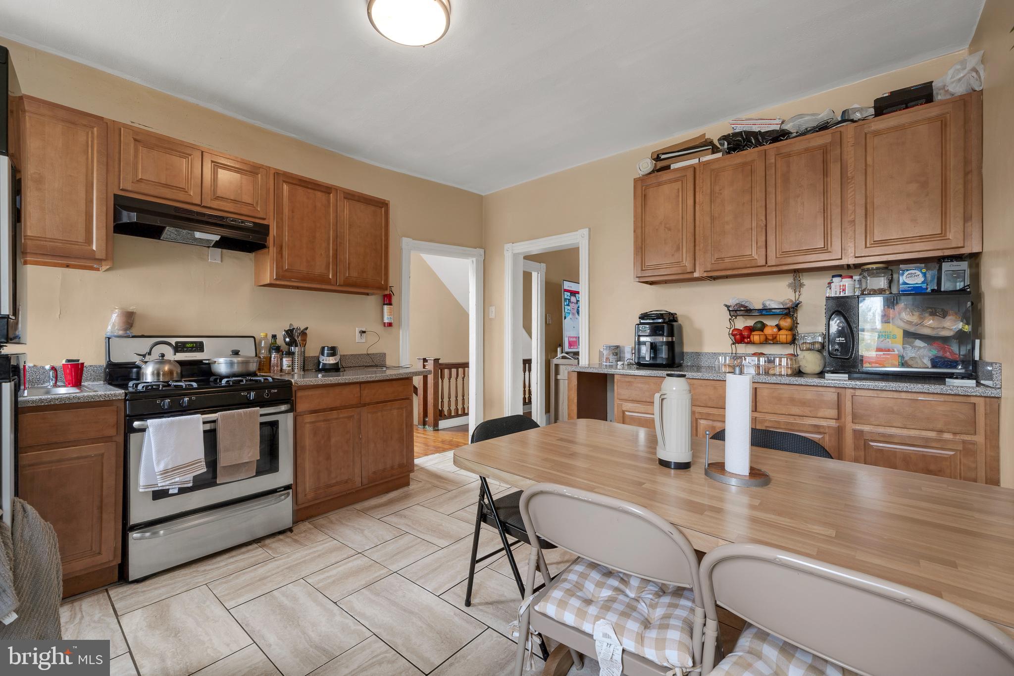 121 Bridgeboro Street Riverside, NJ 08075 - Photo 17 of 34 a kitchen with stainless steel appliances granite countertop a sink a stove a microwave a refrigerator and cabinets