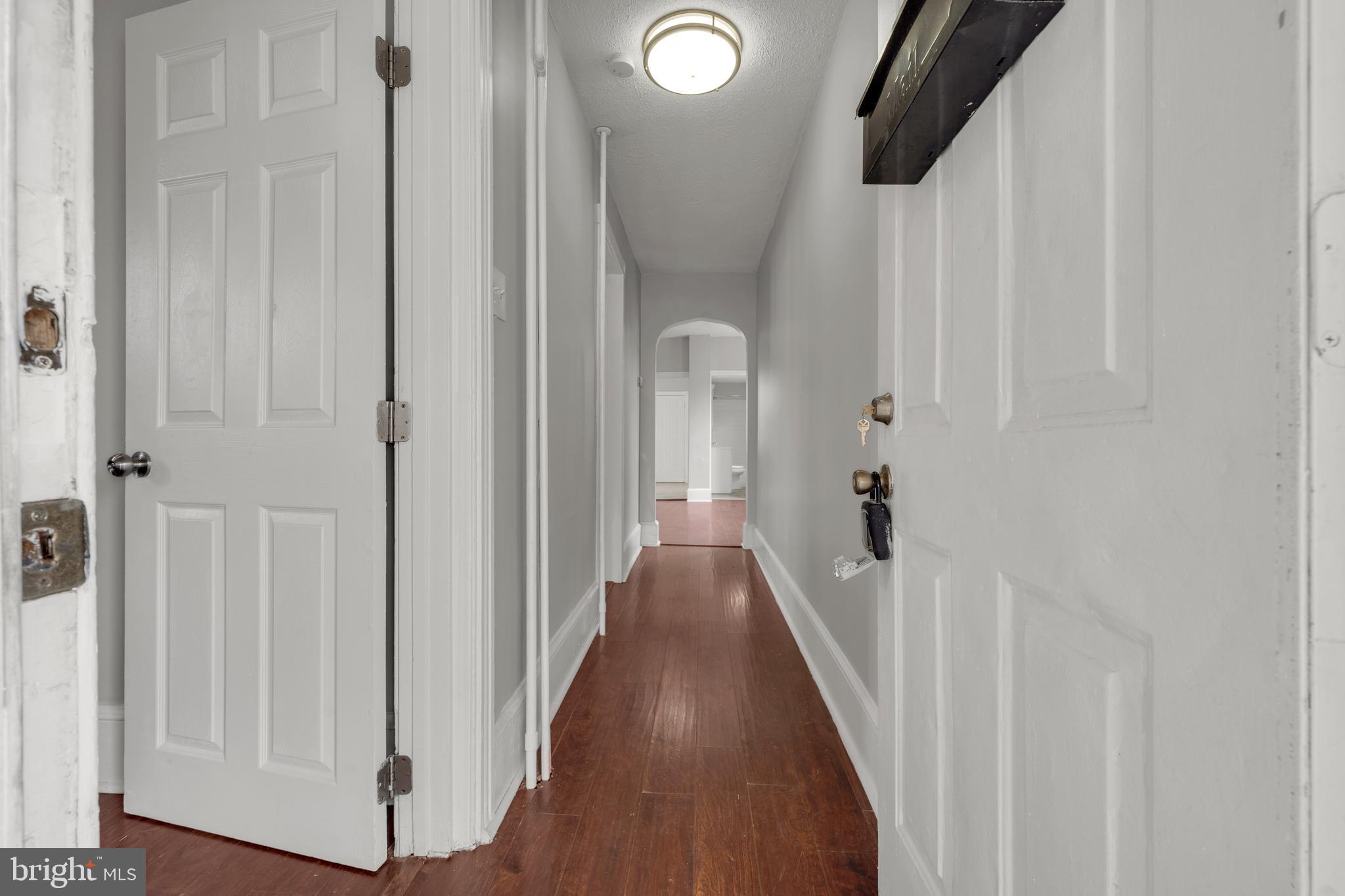 121 Bridgeboro Street Riverside, NJ 08075 - Photo 6 of 34 a view of a hallway with wooden floor and staircase