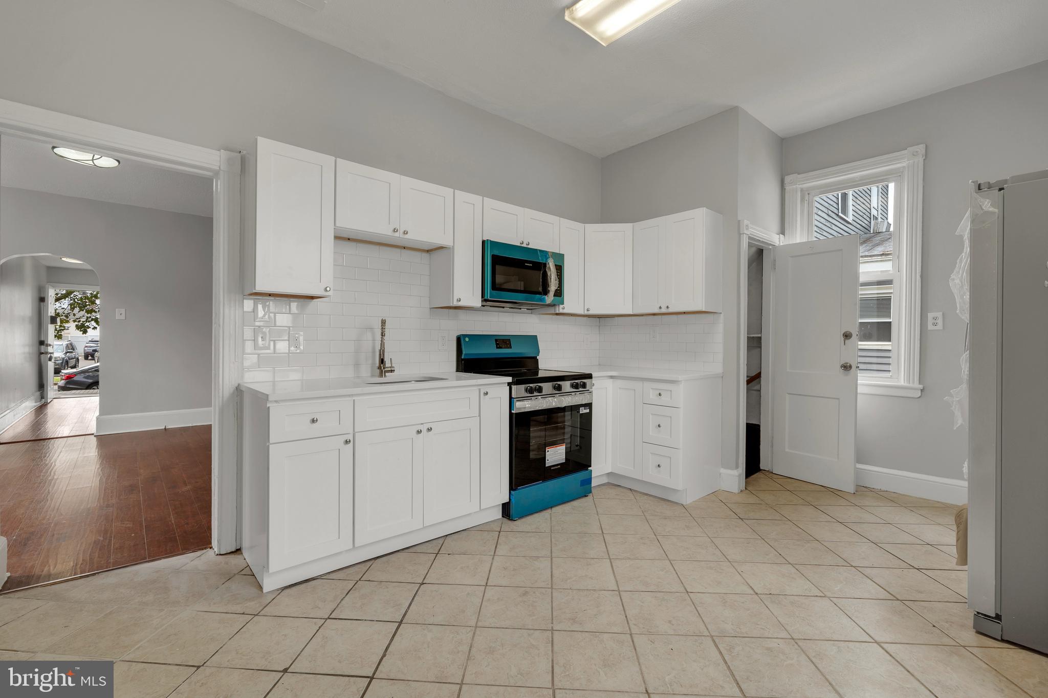 121 Bridgeboro Street Riverside, NJ 08075 - Photo 7 of 34 a kitchen with a stove a sink and a refrigerator