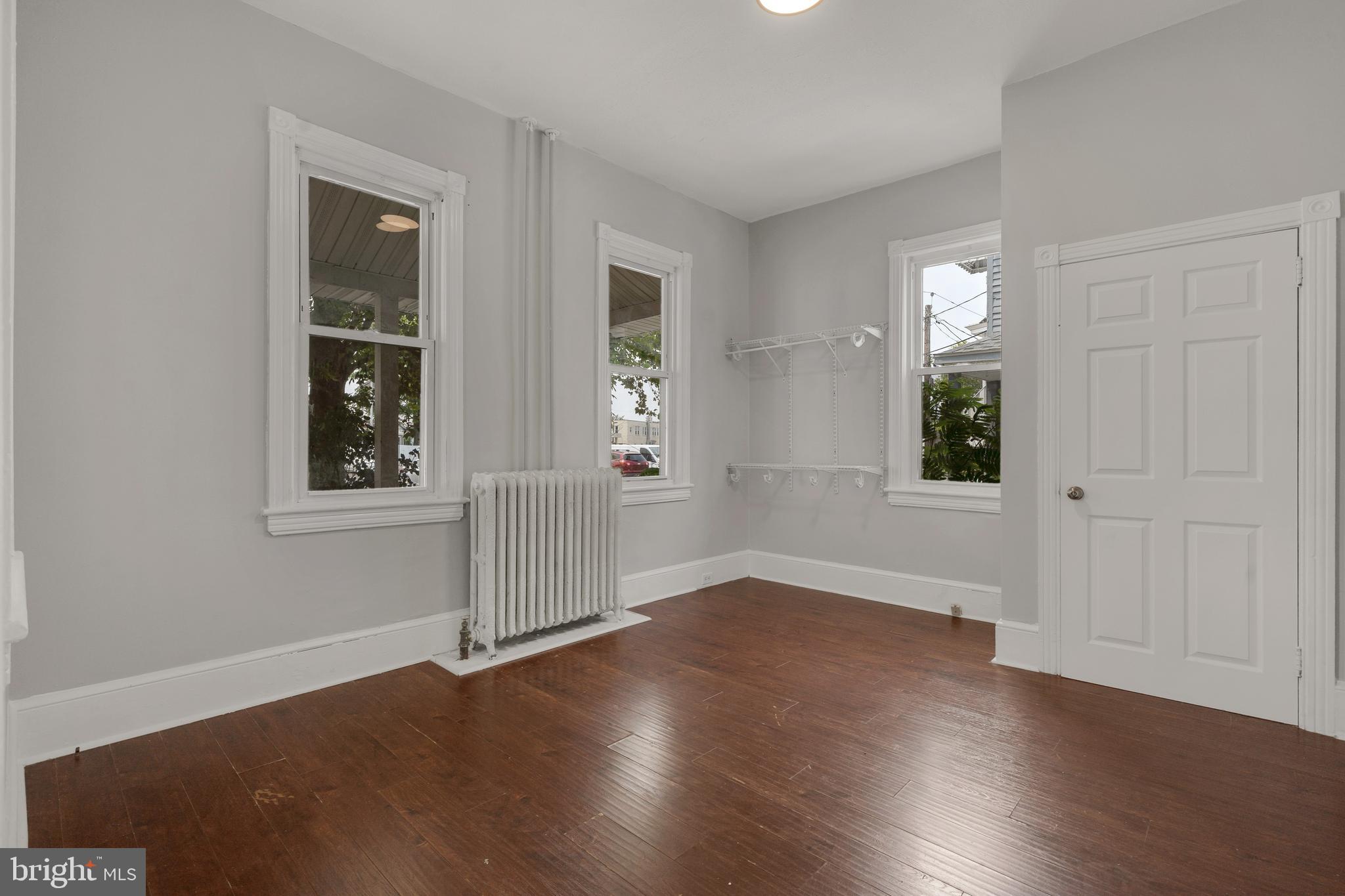 121 Bridgeboro Street Riverside, NJ 08075 - Photo 10 of 34 an empty room with wooden floor and windows