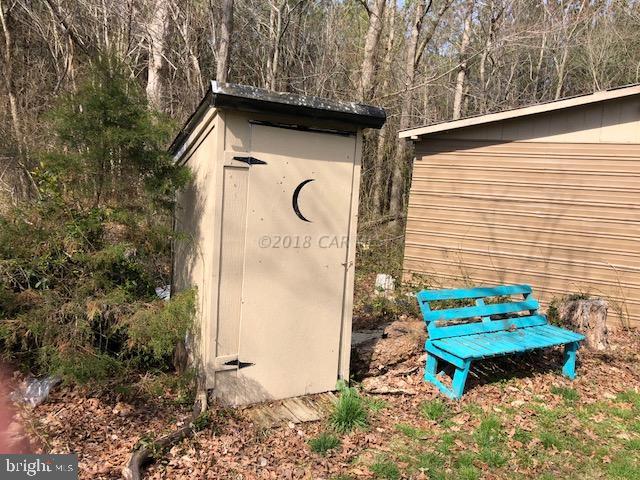 7713 Libertytown Road Berlin, MD 21811 - Photo 14 of 14 a backyard of a house with table and chairs