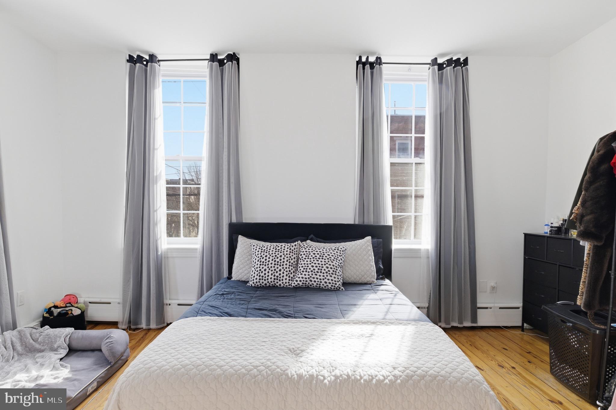 700 South 2nd Street, Unit B1 Philadelphia, PA 19147 - Photo 11 of 18 a bedroom with a bed a flat screen tv and a mirror