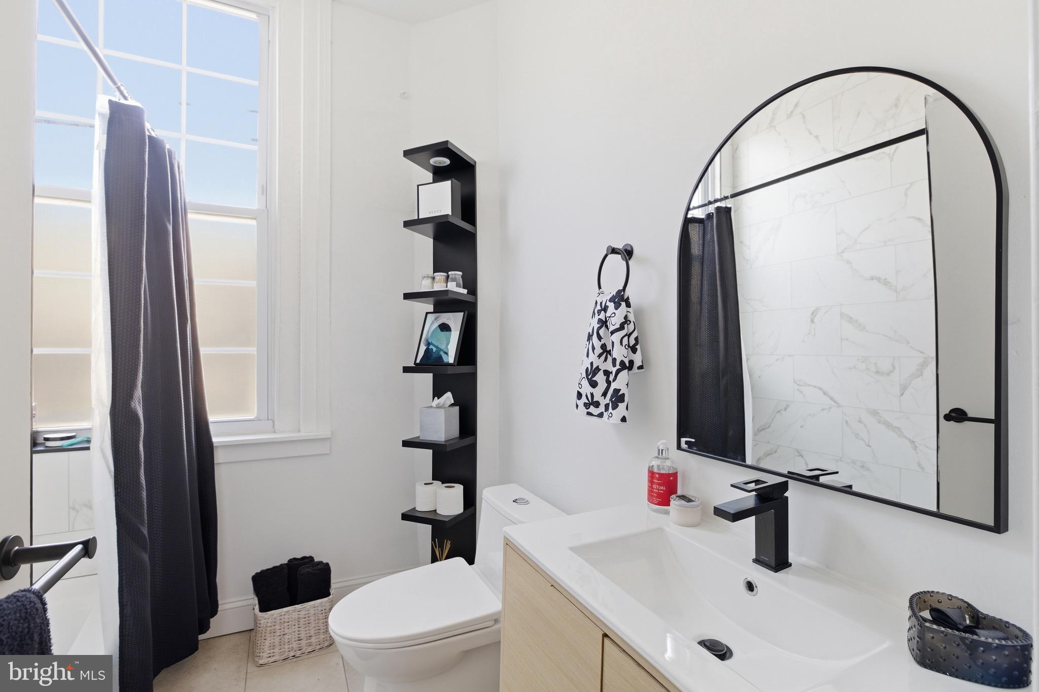 700 South 2nd Street, Unit B1 Philadelphia, PA 19147 - Photo 15 of 18 a bathroom with a sink a toilet and shower