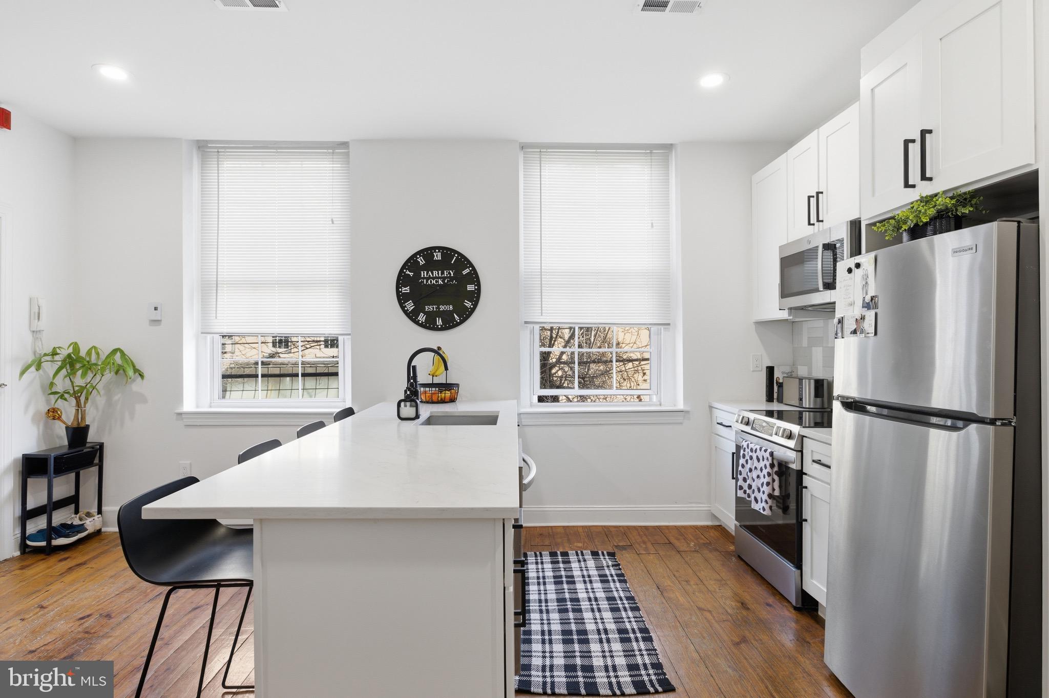 700 South 2nd Street, Unit B1 Philadelphia, PA 19147 - Photo 5 of 18 a kitchen with a refrigerator and a stove top oven