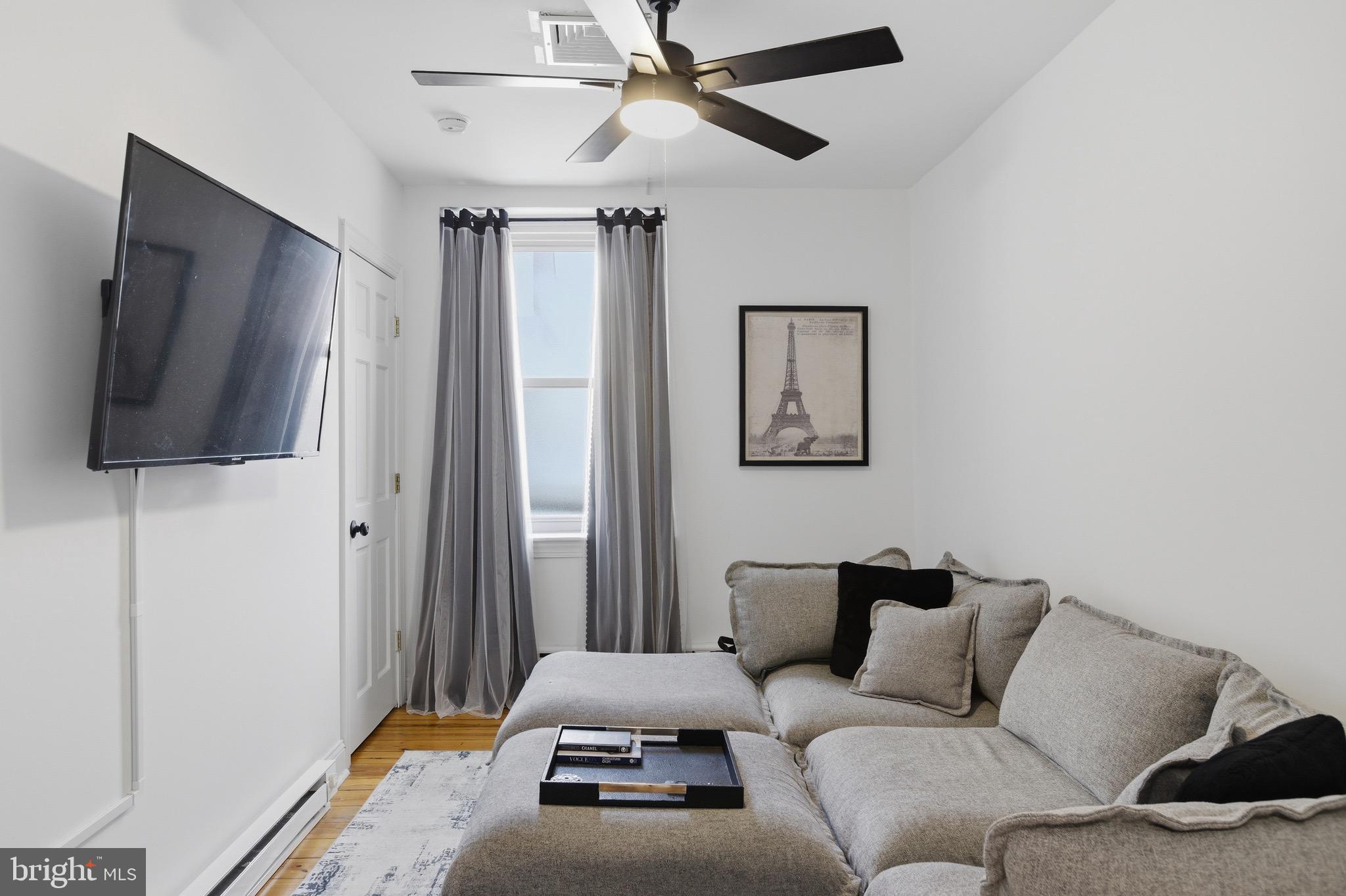 700 South 2nd Street, Unit B1 Philadelphia, PA 19147 - Photo 6 of 18 a living room with furniture and a flat screen tv