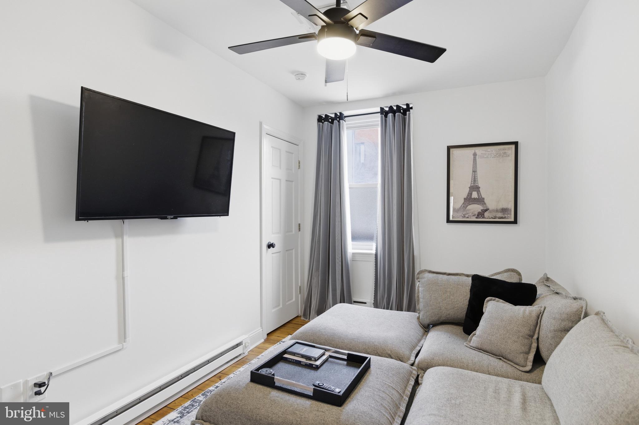 700 South 2nd Street, Unit B1 Philadelphia, PA 19147 - Photo 7 of 18 a living room with furniture and a flat screen tv