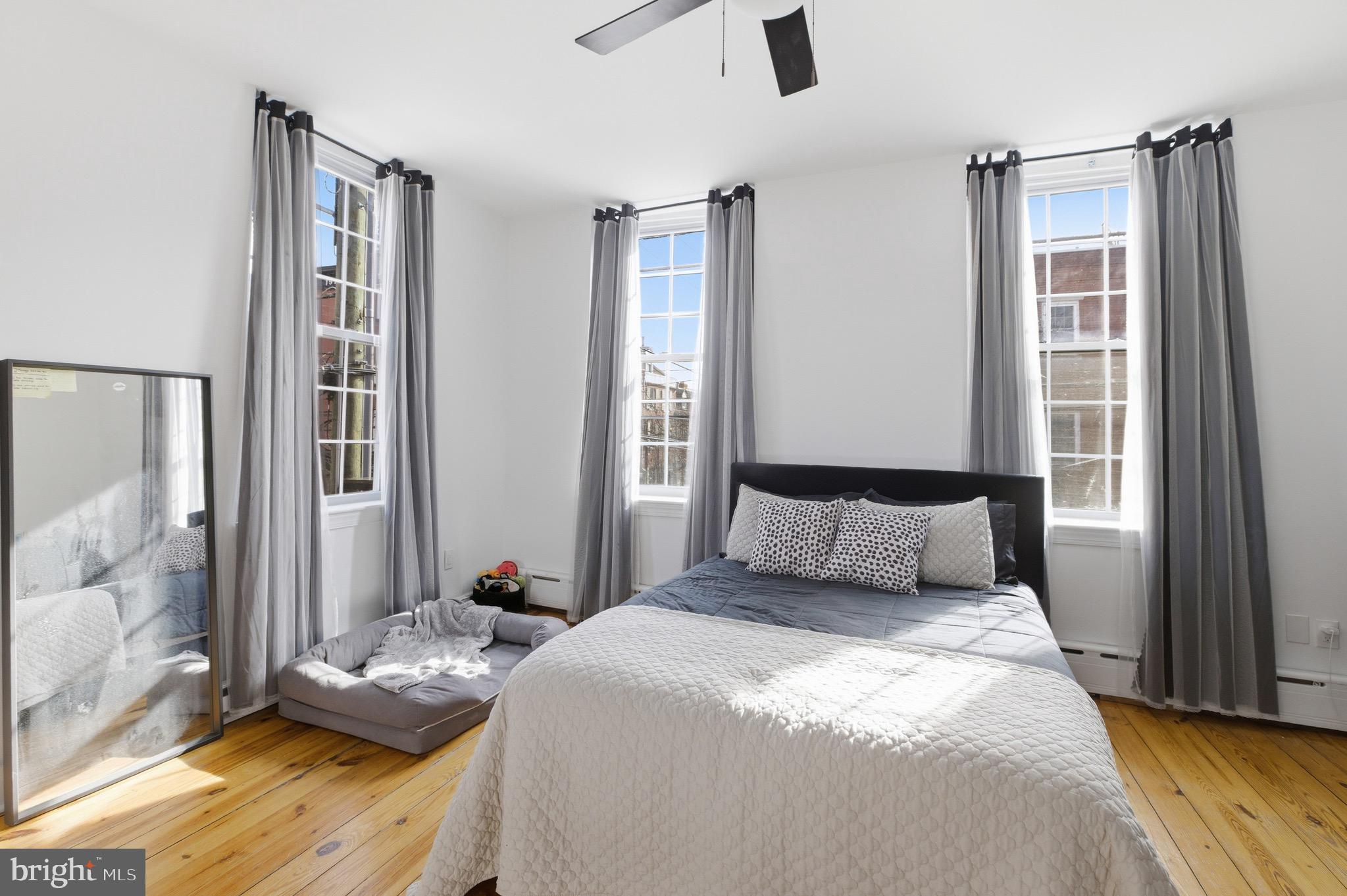 700 South 2nd Street, Unit B1 Philadelphia, PA 19147 - Photo 10 of 18 a bedroom with a bed and wooden floor