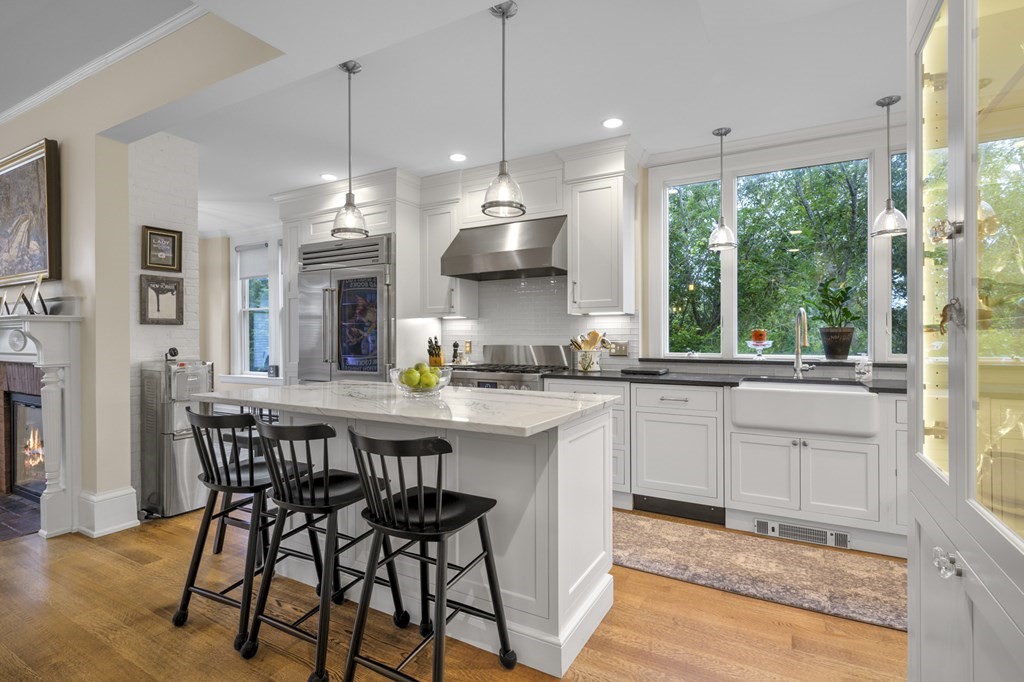 346 Ocean Avenue Marblehead, MA 01945 - Photo 19 of 42 a kitchen with stainless steel appliances granite countertop a stove a refrigerator a kitchen island a table and chairs