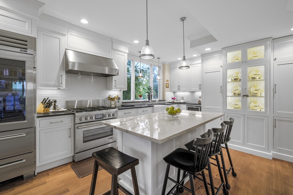 346 Ocean Avenue Marblehead, MA 01945 - Photo 22 of 42 a kitchen with stainless steel appliances granite countertop a stove a sink a oven a dining table and chairs with wooden floor