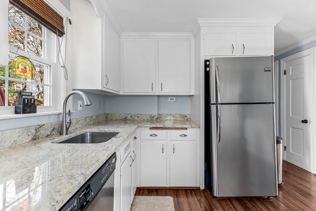 61 Ledgewood Road Dedham, MA 02026 - Photo 12 of 41 a kitchen with stainless steel appliances granite countertop a refrigerator a sink and a stove