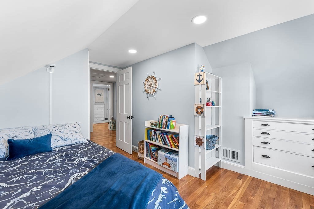 61 Ledgewood Road Dedham, MA 02026 - Photo 19 of 41 a bedroom with a bed and wooden floor