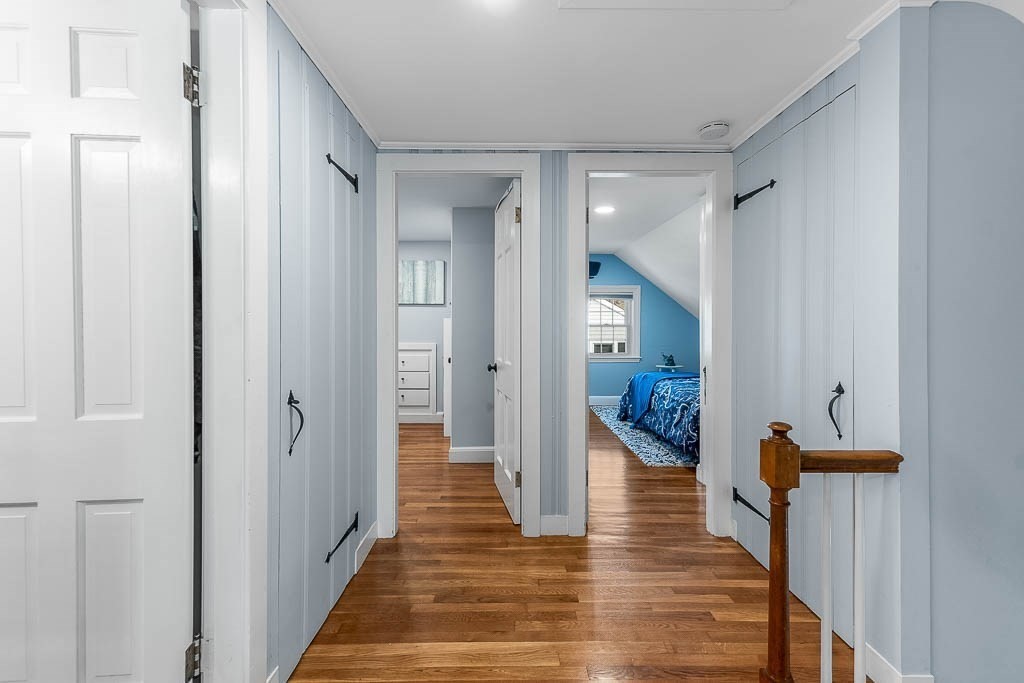 61 Ledgewood Road Dedham, MA 02026 - Photo 27 of 41 a view of a hallway with wooden floor staircase and living room