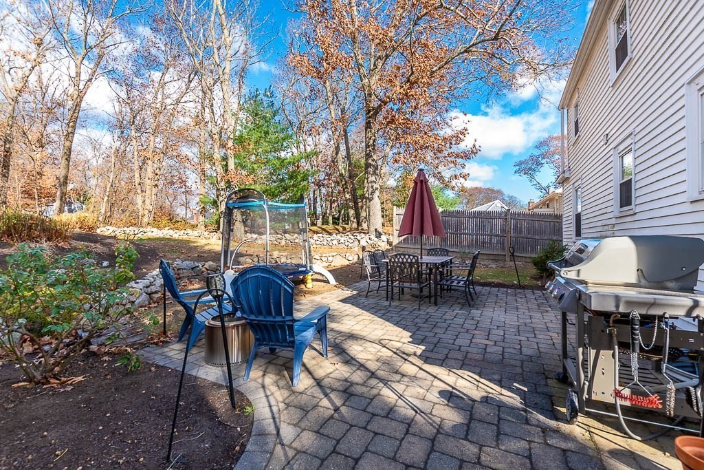 61 Ledgewood Road Dedham, MA 02026 - Photo 30 of 41 a view of a patio with table and chairs and potted plants