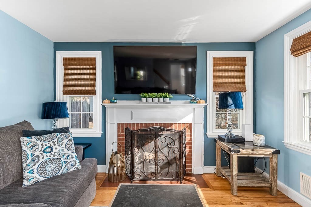 61 Ledgewood Road Dedham, MA 02026 - Photo 6 of 41 a living room with furniture a flat screen tv and a fireplace