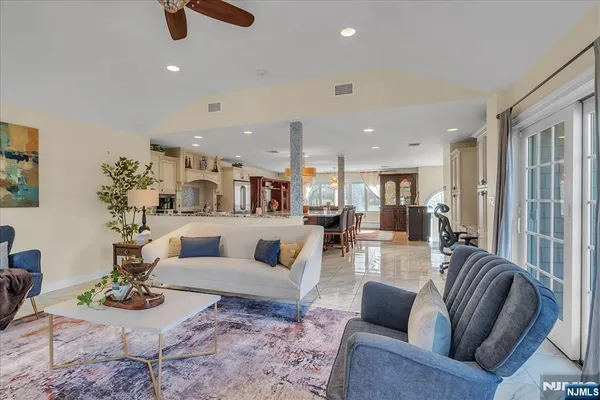 a view of a dining room and livingroom with furniture window and wooden floor