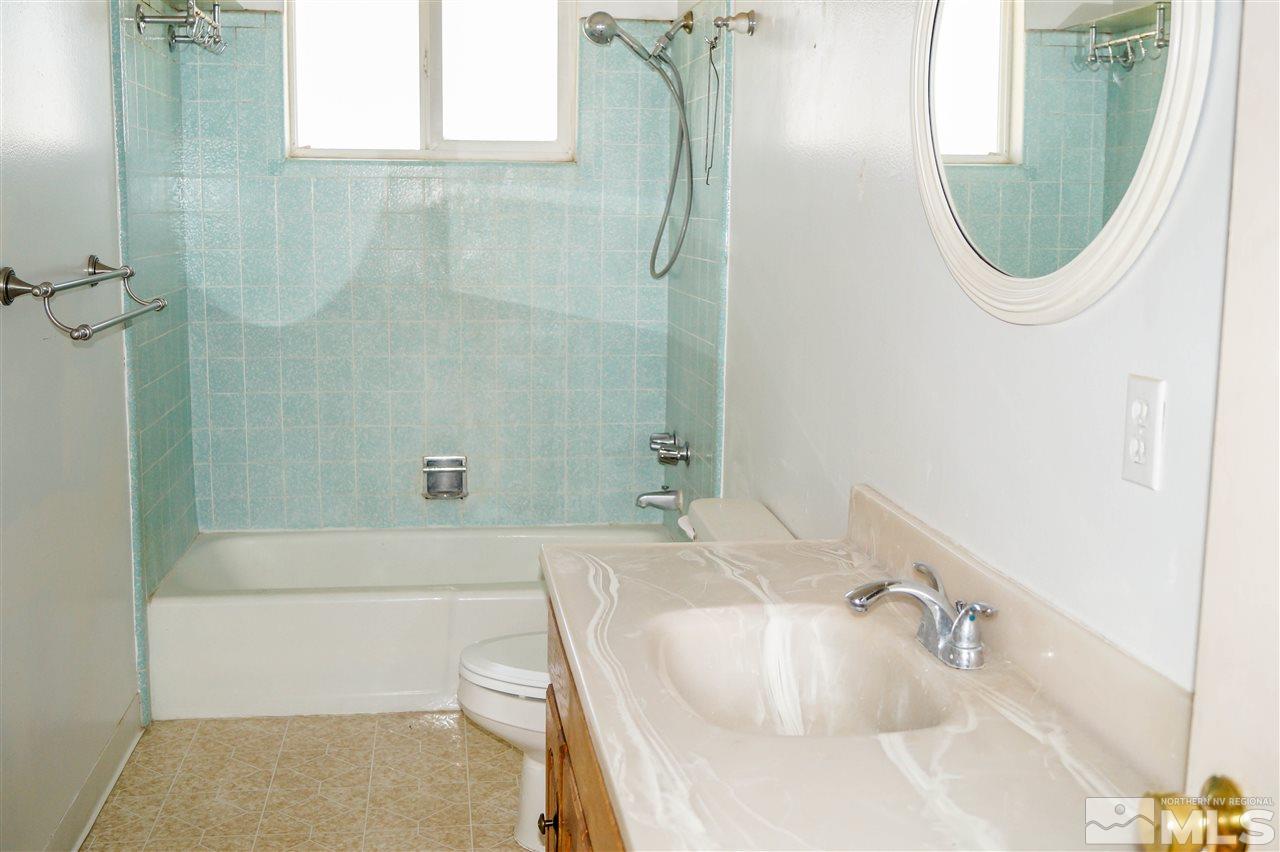 10795 Santa Fe Road Reno, NV 89508 - Photo 8 of 17 a bathroom with a sink a toilet and shower