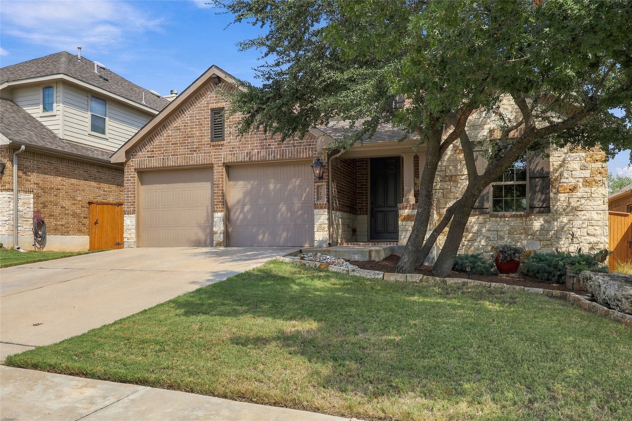 320 Fort Cobb Way Georgetown, TX 78628 - Photo 32 of 37 Stone and brick facade detailing paired with a neatly manicured lawn enhances this classic exterior.