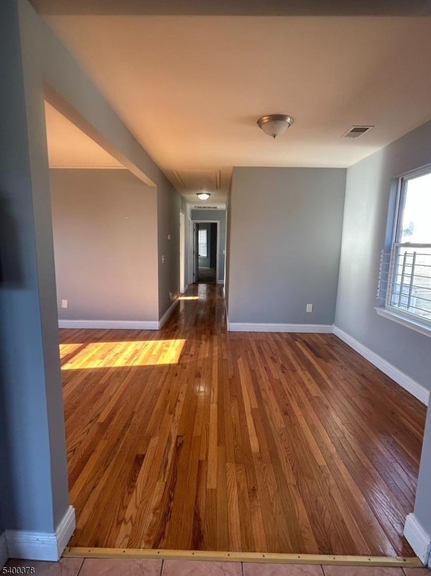 392 South 8th Street, Unit 2 Newark, NJ 07103 - Photo 6 of 6 wooden floor in an empty room with a window