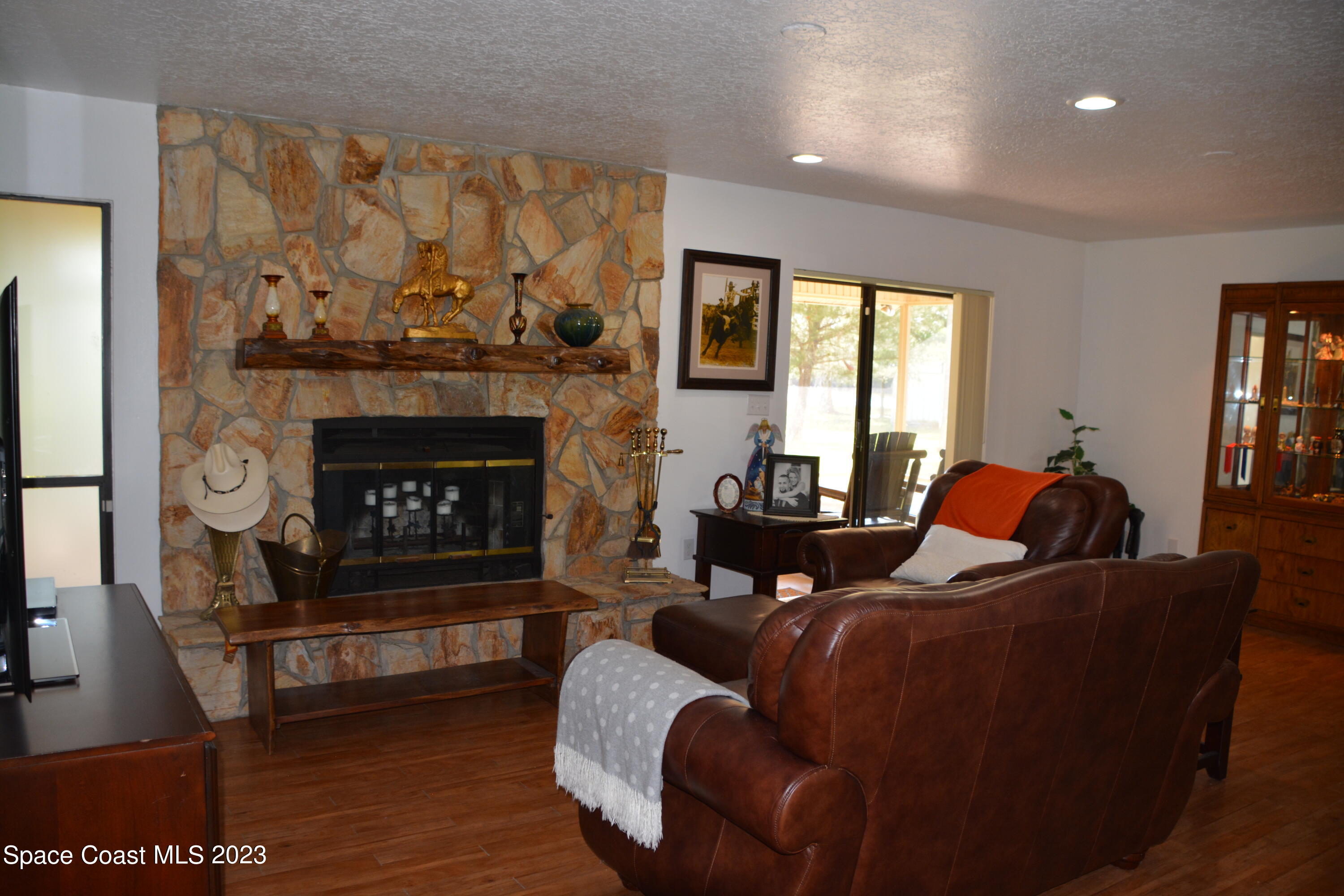 1045 Pine Island Road Merritt Island, FL 32953 - Photo 7 of 42 a living room with furniture and a fireplace