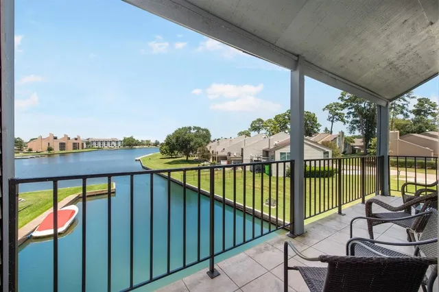 a view of a balcony with lake view and wooden floor