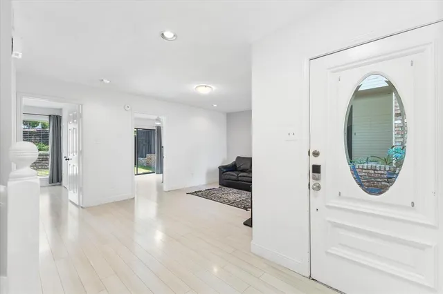 wooden floor view with staircase and living room