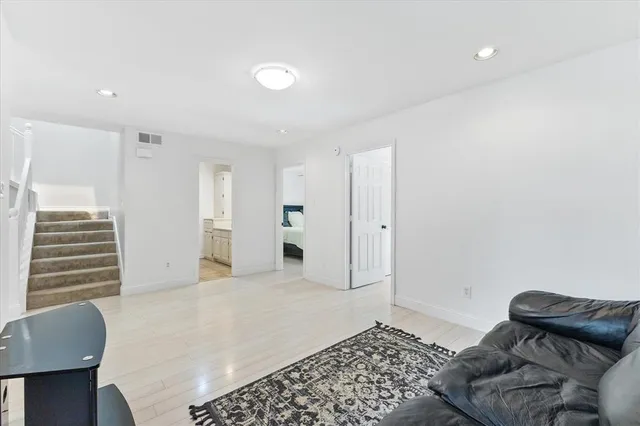 a bedroom with furniture and a chair