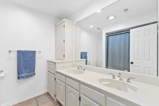 a bathroom with 2 sink and a mirror