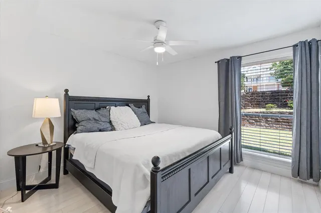 a bedroom with a bed and a window