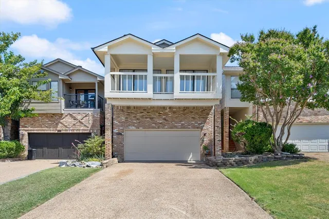 a front view of a house with a garden and garage