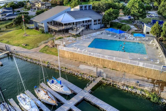 an aerial view of a house with swimming pool garden and patio