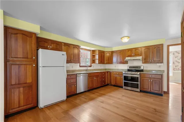 a kitchen with refrigerator a stove top oven and refrigerator