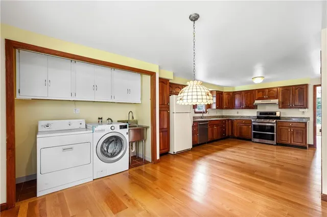 a kitchen with kitchen island a stove a sink and a refrigerator