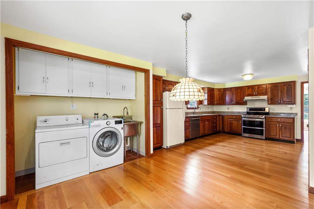 1413 Terrace Drive Pittsburgh, PA 15228 - Photo 15 of 50 a kitchen with kitchen island a stove a sink and a refrigerator