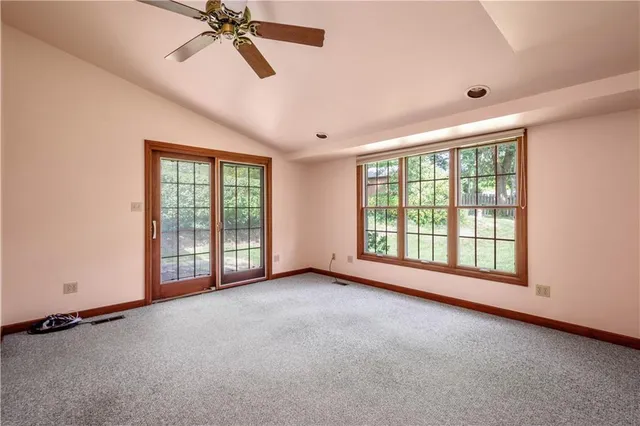a view of room with window and a ceiling fan