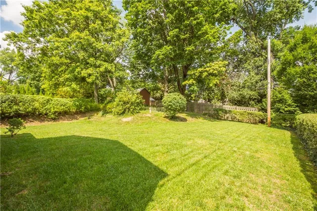 a view of yard with swimming pool and green space