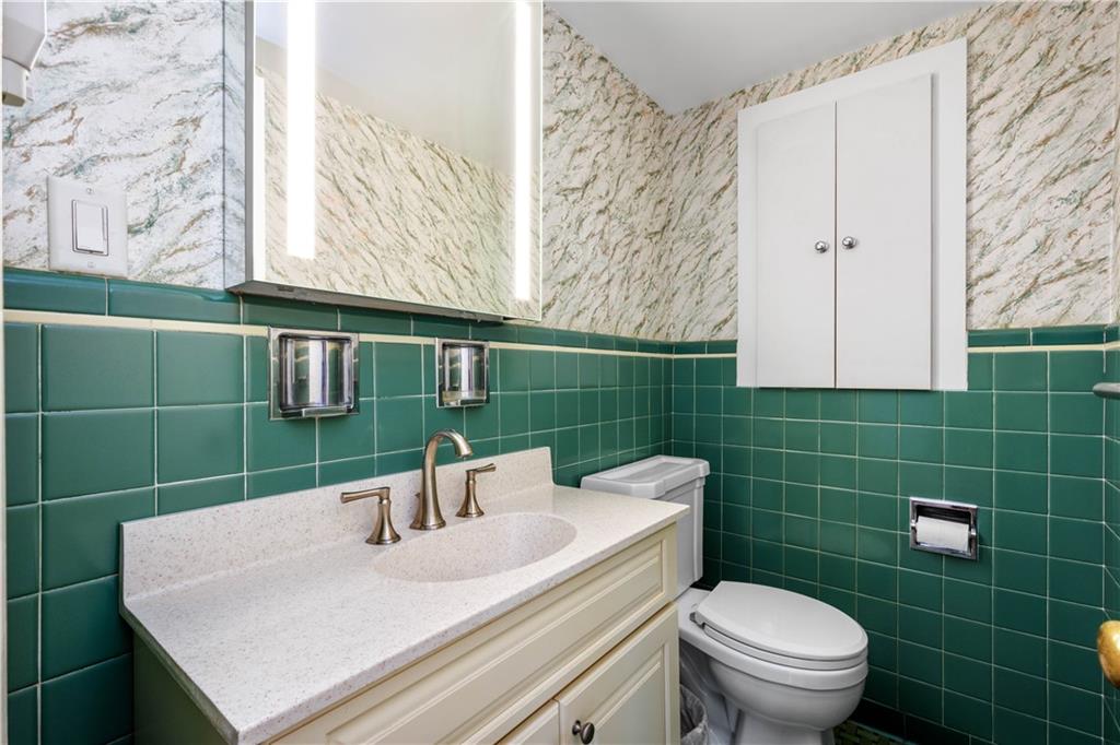 1413 Terrace Drive Pittsburgh, PA 15228 - Photo 29 of 50 a bathroom with a sink a toilet and a mirror