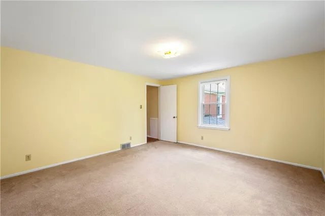 an empty room with a empty space and a window