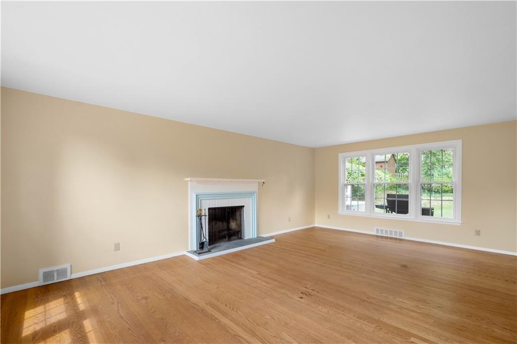1413 Terrace Drive Pittsburgh, PA 15228 - Photo 6 of 50 an empty room with a fireplace and windows