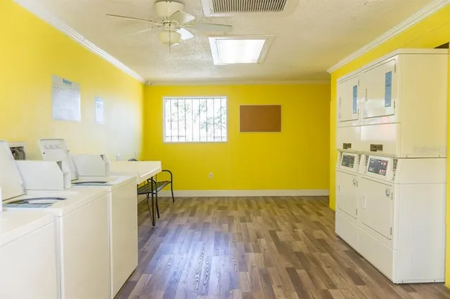 a view of a kitchen with wooden floor and a refrigerator