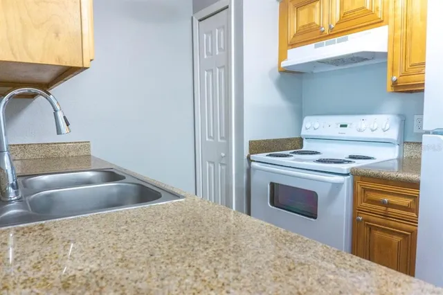 a kitchen with a stove and a sink