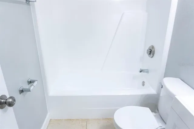 a bathroom with a toilet and bathtub