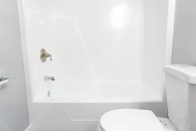 a bathroom with a toilet and a bathtub