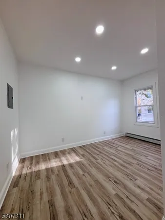 a view of room with wooden floor and window
