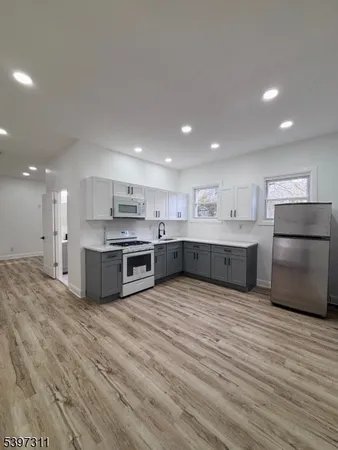 a large kitchen with stainless steel appliances granite countertop a large counter top and oven
