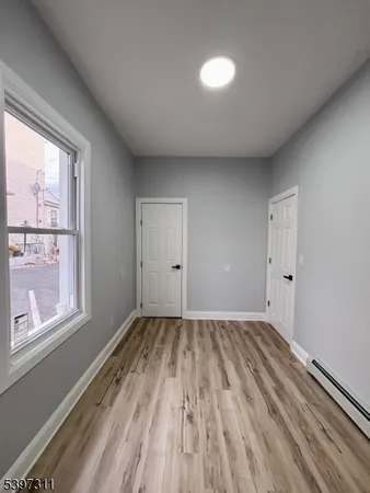a view of room with window and wooden floor