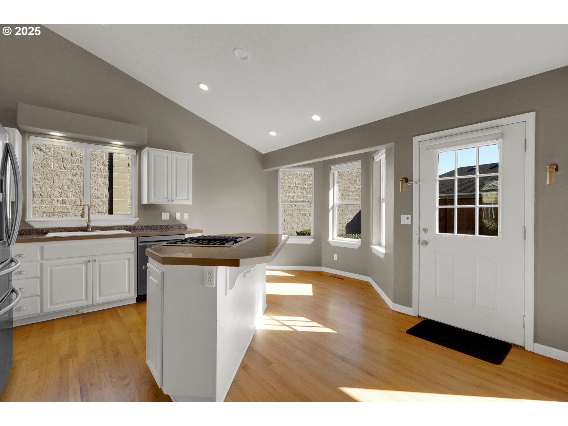 1587 Manchester Drive Eugene, OR 97401 - Photo 13 of 31 a kitchen with stainless steel appliances granite countertop a stove a sink and a refrigerator with wooden floor