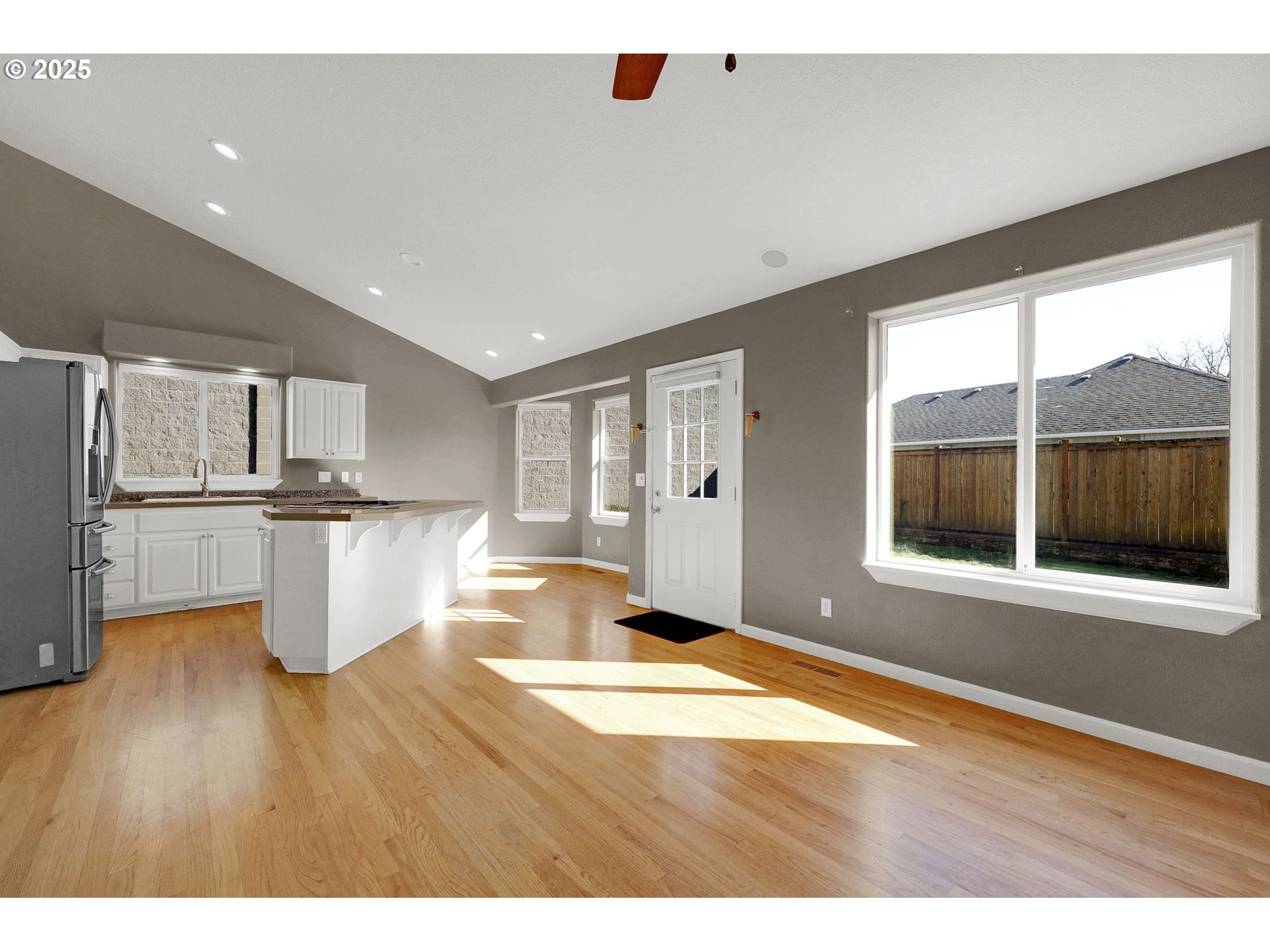 1587 Manchester Drive Eugene, OR 97401 - Photo 16 of 31 a open kitchen with granite countertop a refrigerator oven stove and a sink with wooden floor